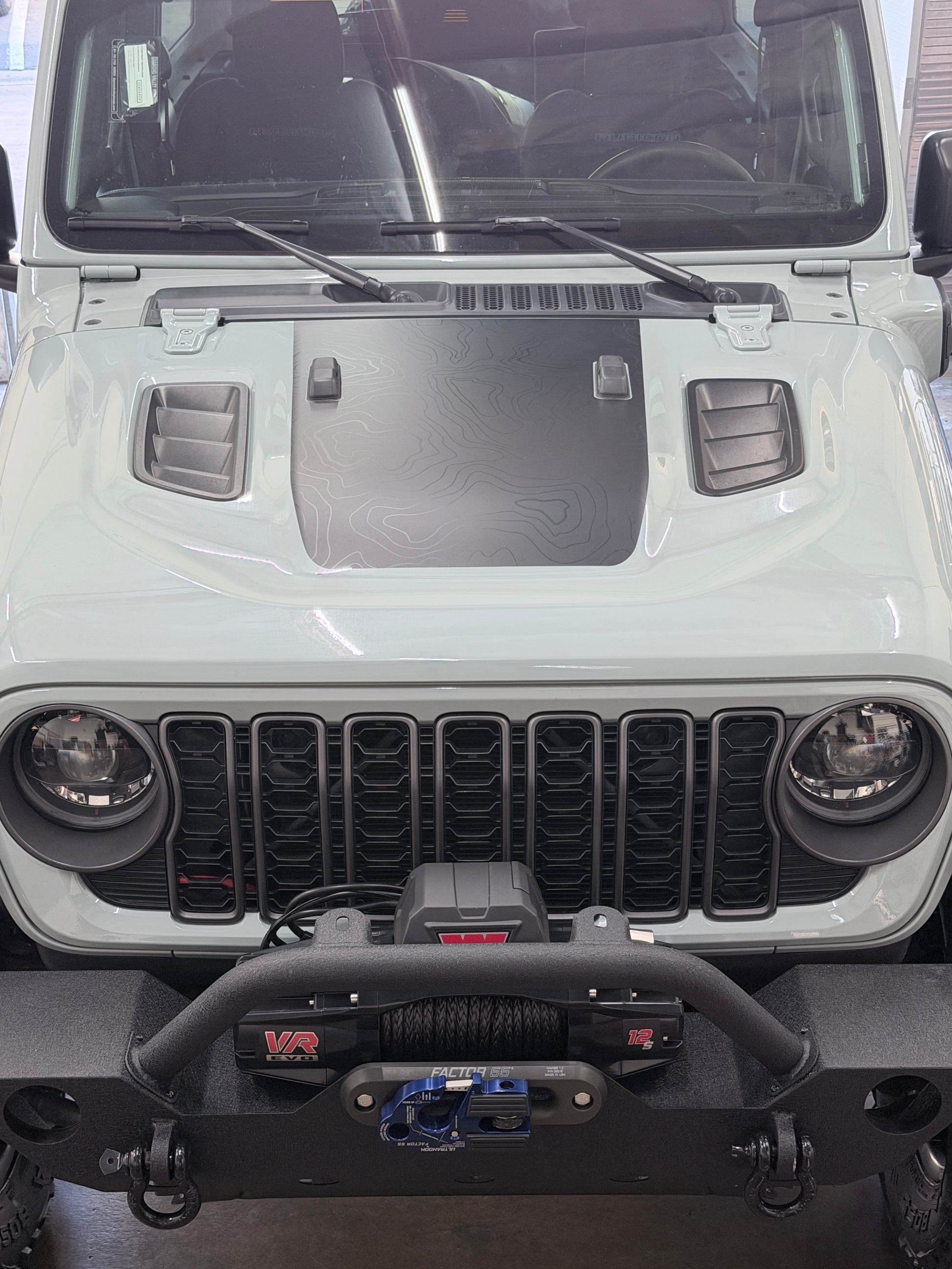 Topographic hood wrap with matte black terrain pattern installed on Jeep Rubicon by Beyond Wraps