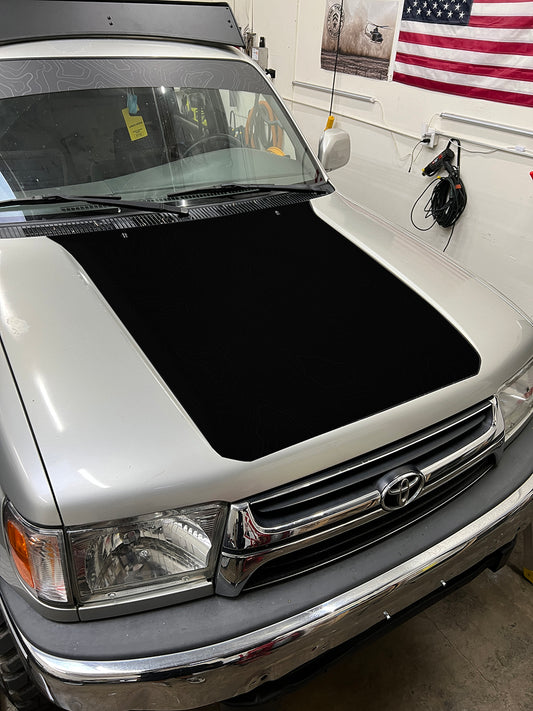 Photo of a 3rd generation Toyota 4Runner, with a black vinyl sticker that covers about half of the hood.